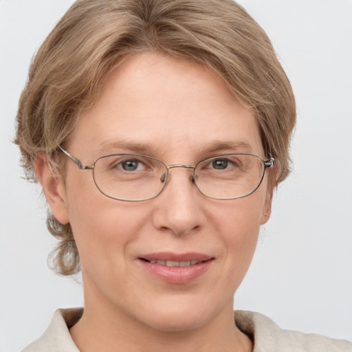 Joyful white adult female with short  brown hair and grey eyes