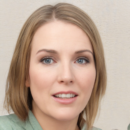 Joyful white young-adult female with medium  brown hair and blue eyes