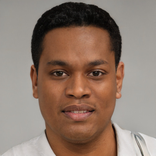Joyful black young-adult male with short  black hair and brown eyes