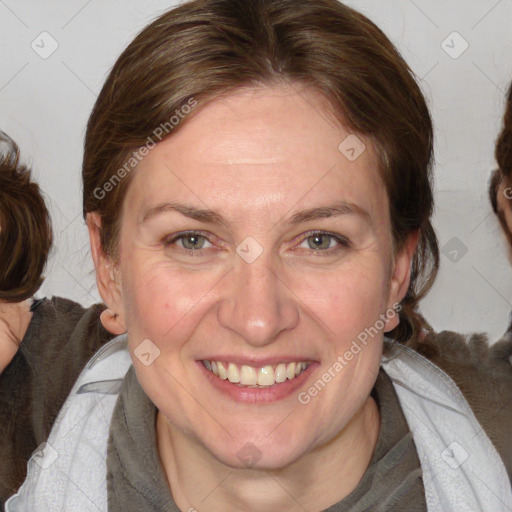 Joyful white adult female with medium  brown hair and blue eyes