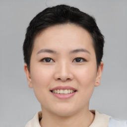 Joyful asian young-adult female with short  black hair and brown eyes