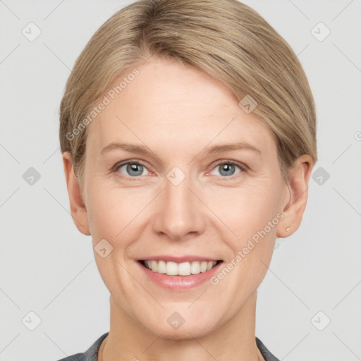 Joyful white young-adult female with short  brown hair and grey eyes