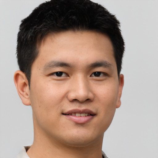 Joyful asian young-adult male with short  brown hair and brown eyes