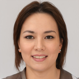 Joyful white young-adult female with medium  brown hair and brown eyes