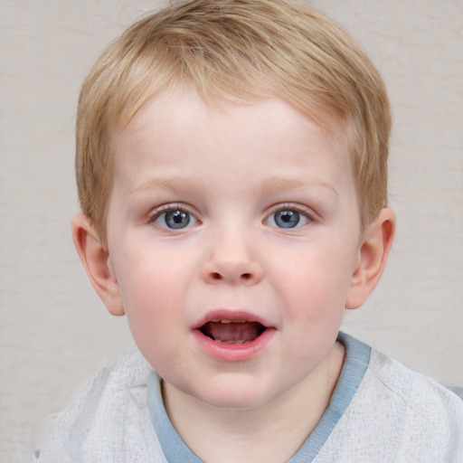 Joyful white child male with short  brown hair and blue eyes