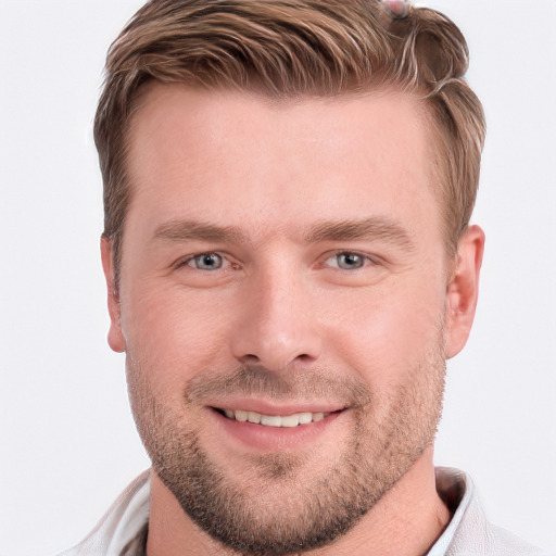 Joyful white young-adult male with short  brown hair and blue eyes