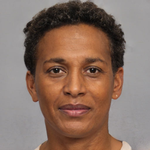Joyful black adult male with short  brown hair and brown eyes