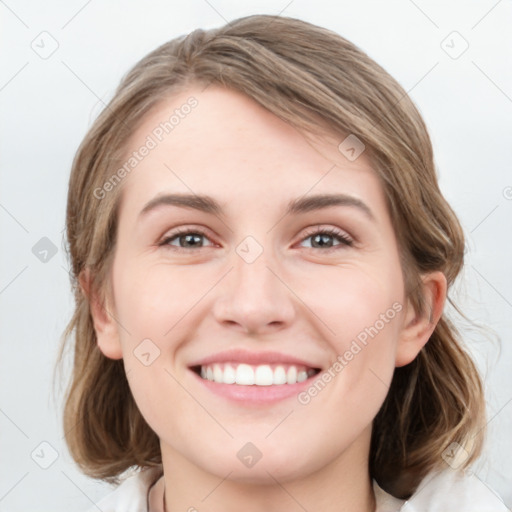 Joyful white young-adult female with medium  brown hair and green eyes