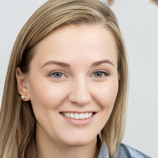 Joyful white young-adult female with long  brown hair and blue eyes