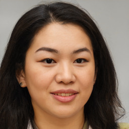 Joyful asian young-adult female with long  brown hair and brown eyes