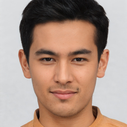 Joyful asian young-adult male with short  black hair and brown eyes