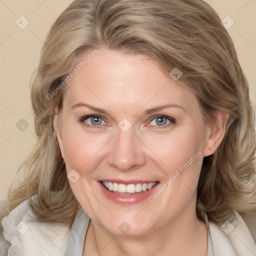 Joyful white adult female with medium  brown hair and blue eyes