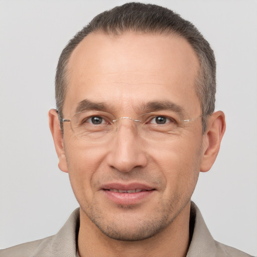 Joyful white adult male with short  brown hair and brown eyes