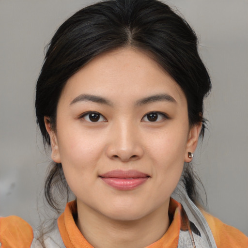 Joyful asian young-adult female with medium  brown hair and brown eyes