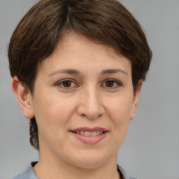 Joyful white adult female with short  brown hair and brown eyes