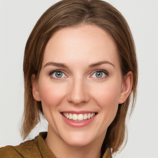 Joyful white young-adult female with medium  brown hair and blue eyes