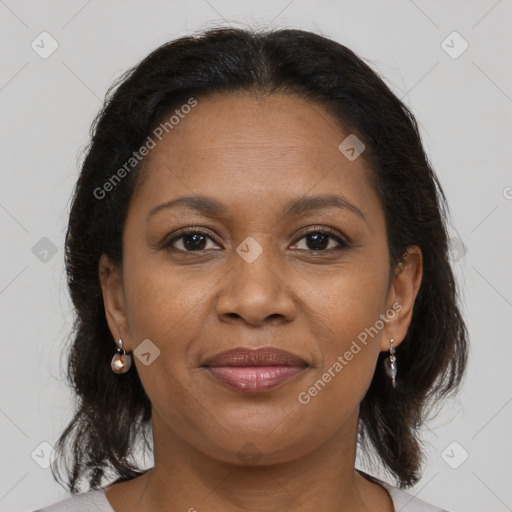 Joyful black adult female with medium  brown hair and brown eyes