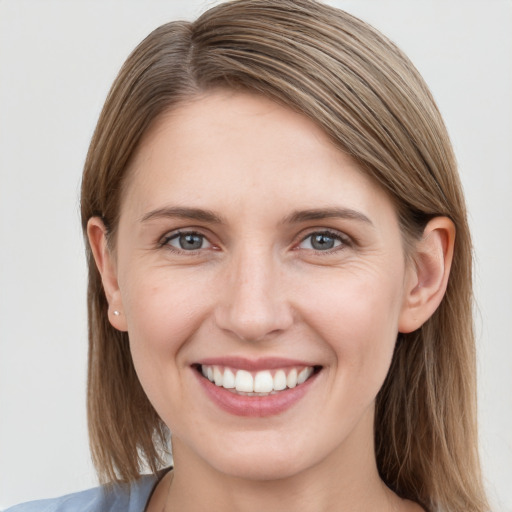 Joyful white young-adult female with long  brown hair and grey eyes