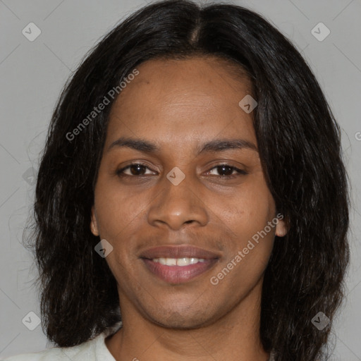 Joyful black young-adult female with long  brown hair and brown eyes