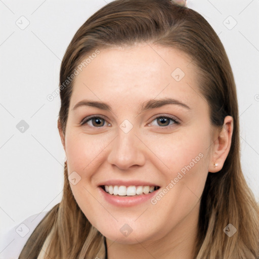 Joyful white young-adult female with long  brown hair and grey eyes