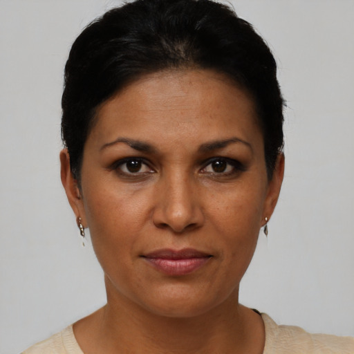 Joyful latino young-adult female with short  black hair and brown eyes