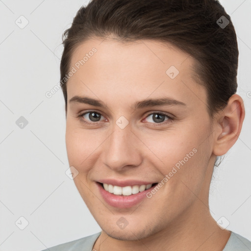 Joyful white young-adult female with short  brown hair and brown eyes