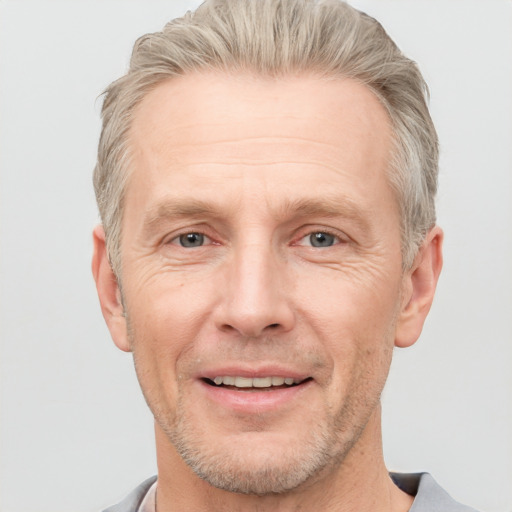 Joyful white adult male with short  brown hair and grey eyes