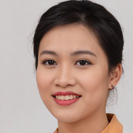 Joyful asian young-adult female with long  brown hair and brown eyes