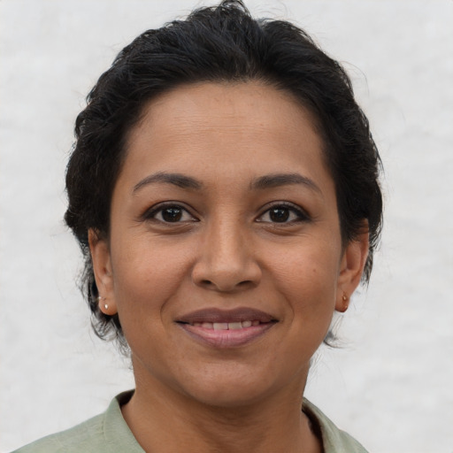 Joyful latino adult female with short  brown hair and brown eyes