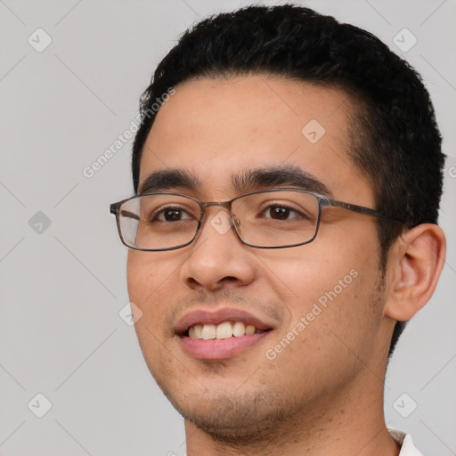 Joyful white young-adult male with short  black hair and brown eyes