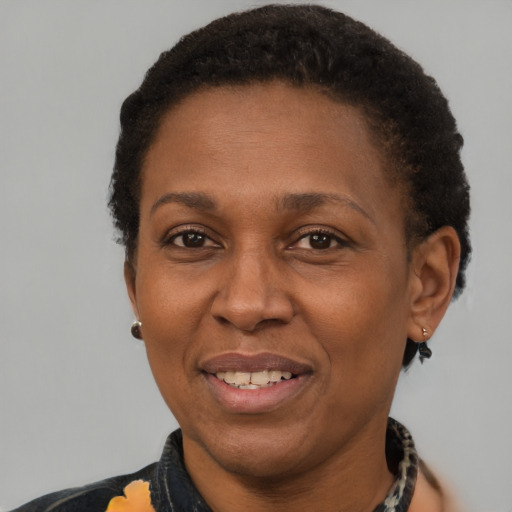 Joyful latino adult female with short  brown hair and brown eyes