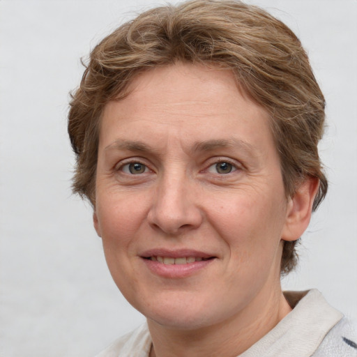 Joyful white adult female with short  brown hair and grey eyes