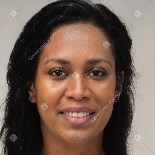 Joyful black young-adult female with long  brown hair and brown eyes