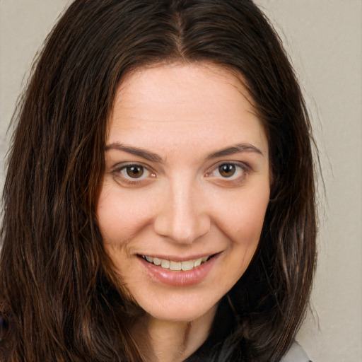 Joyful white young-adult female with long  brown hair and brown eyes