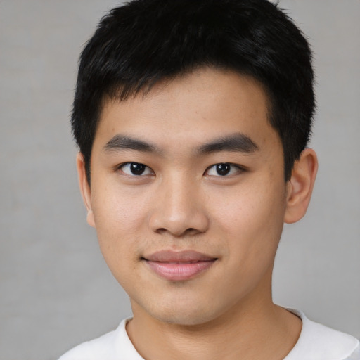 Joyful asian young-adult male with short  black hair and brown eyes