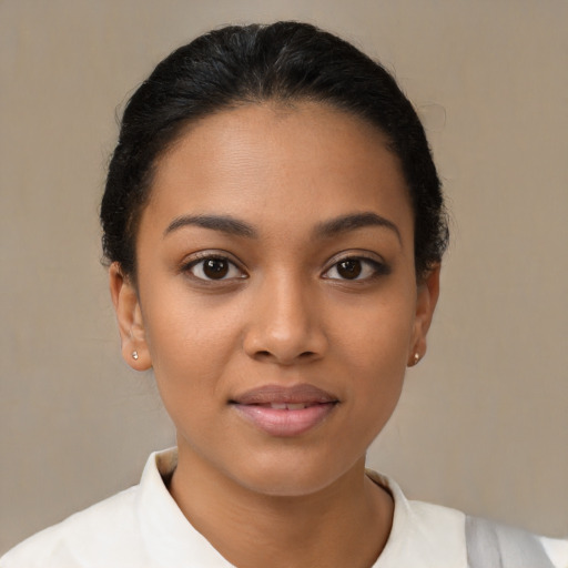 Joyful latino young-adult female with short  brown hair and brown eyes