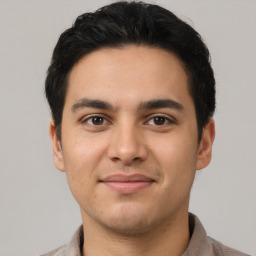 Joyful latino young-adult male with short  brown hair and brown eyes