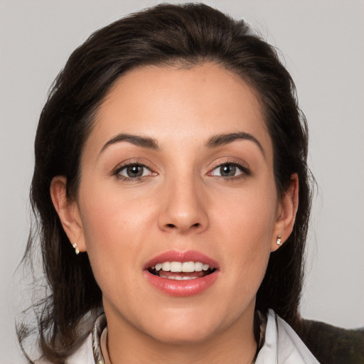 Joyful white young-adult female with medium  brown hair and brown eyes