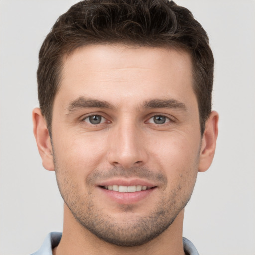 Joyful white young-adult male with short  brown hair and brown eyes