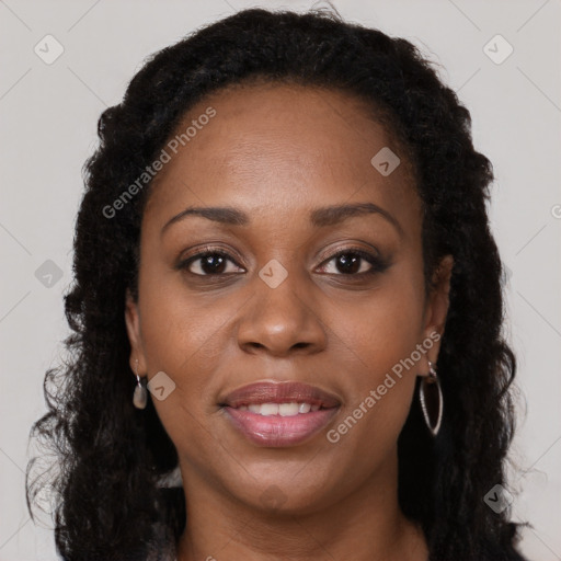 Joyful black young-adult female with long  brown hair and brown eyes