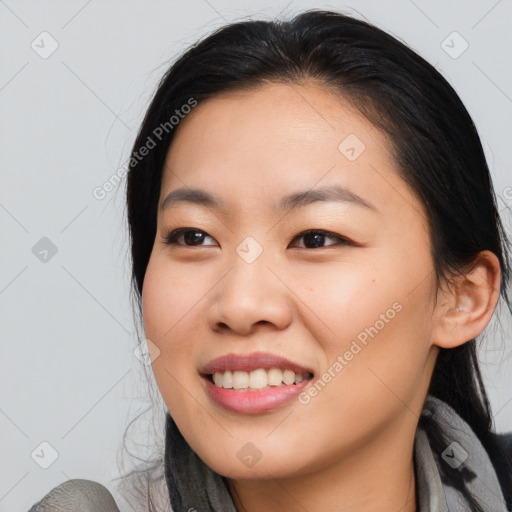 Joyful asian young-adult female with medium  black hair and brown eyes