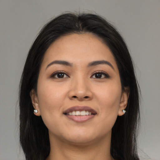 Joyful asian young-adult female with long  brown hair and brown eyes