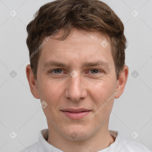 Joyful white adult male with short  brown hair and grey eyes