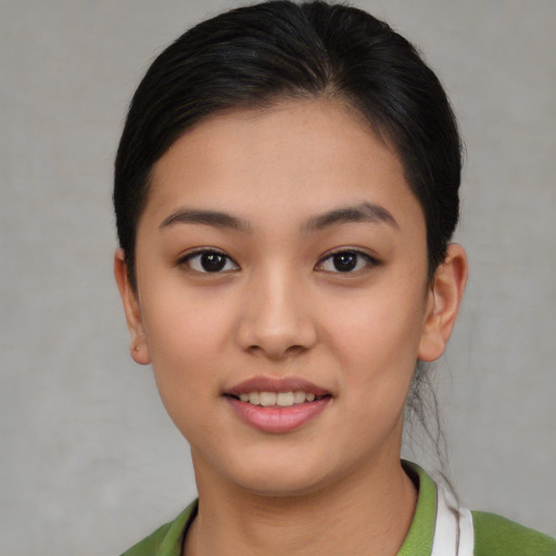Joyful asian young-adult female with short  brown hair and brown eyes