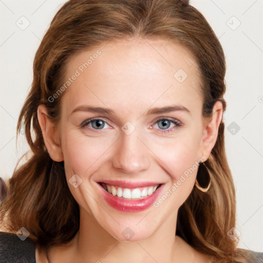 Joyful white young-adult female with long  brown hair and blue eyes