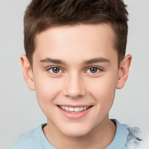 Joyful white child male with short  brown hair and brown eyes