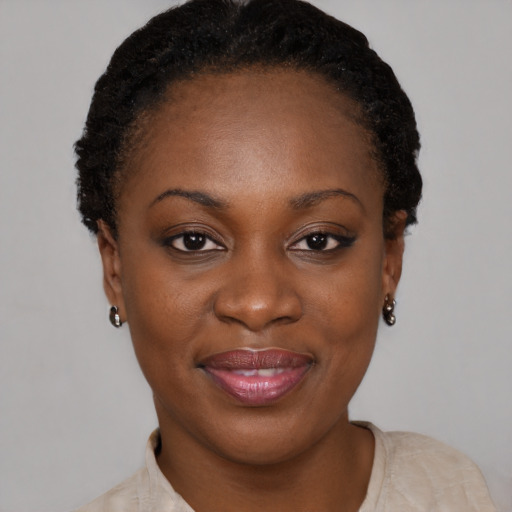 Joyful black young-adult female with short  brown hair and brown eyes
