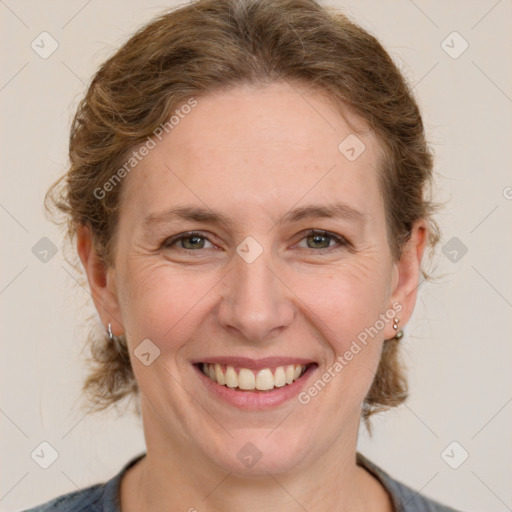 Joyful white adult female with medium  brown hair and grey eyes