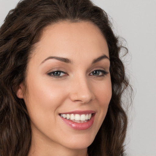 Joyful white young-adult female with long  brown hair and brown eyes