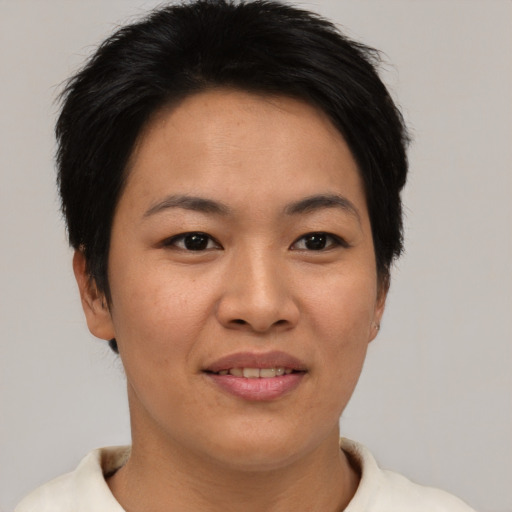 Joyful asian young-adult female with short  brown hair and brown eyes